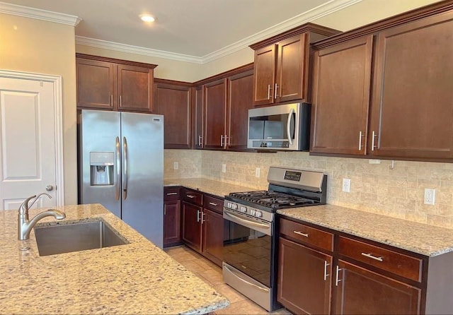 12714 Sweet Root Ln, Humble, TX 77346 - kitchen with stainless steel appliances, a sink, light stone counters, crown molding, and decorative backsplash