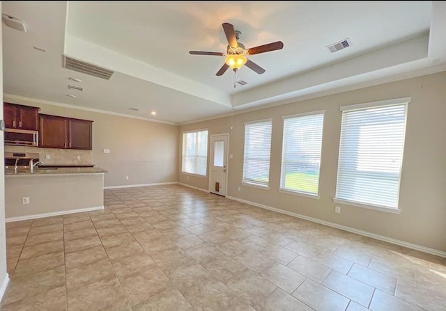 12714 Sweet Root Ln, Humble, TX 77346 - unfurnished living room featuring a tray ceiling, a ceiling fan, ornamental molding, baseboards, and recessed lighting
