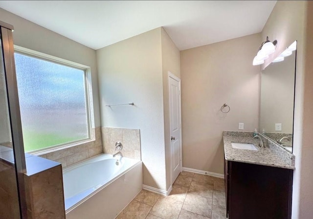 12714 Sweet Root Ln, Humble, TX 77346 - bathroom featuring a bath, vanity, tile patterned floors, and baseboards