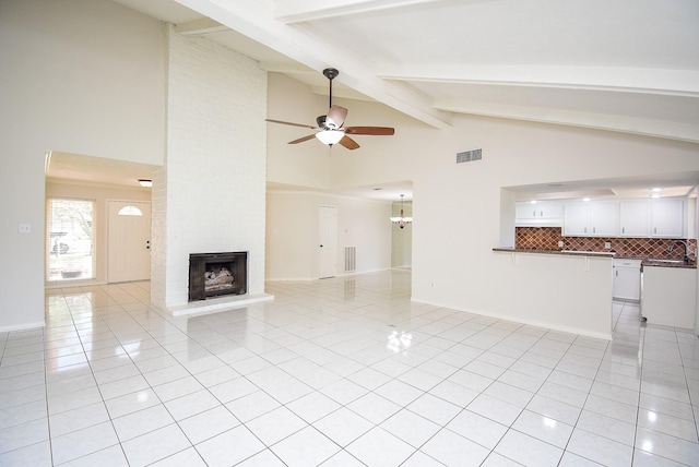 3119 Wagon Trail Dr, Sugar Land, TX 77479 - unfurnished living room featuring light tile patterned floors, a ceiling fan, high vaulted ceiling, beamed ceiling, and a sink