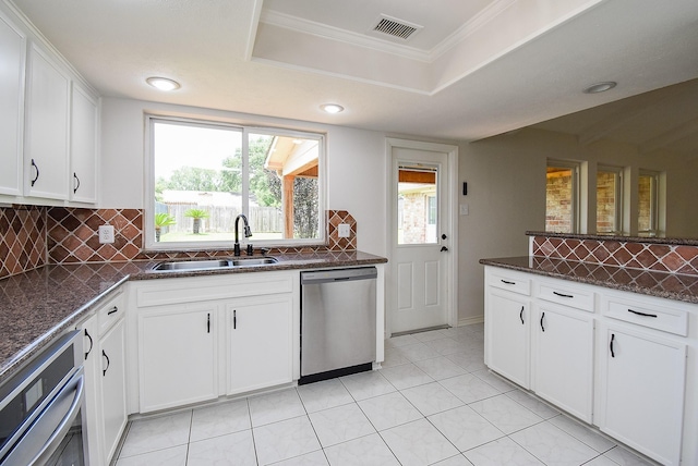 3119 Wagon Trail Dr, Sugar Land, TX 77479 - kitchen featuring stainless steel appliances, a sink, decorative backsplash, white cabinetry, and recessed lighting