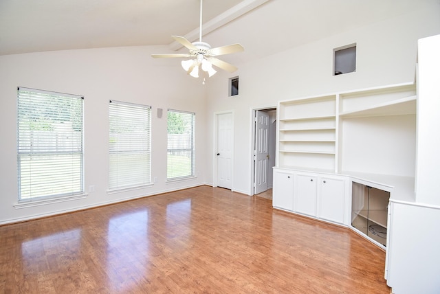 3119 Wagon Trail Dr, Sugar Land, TX 77479 - unfurnished living room with ceiling fan, plenty of natural light, beamed ceiling, light wood-style flooring, and high vaulted ceiling