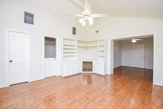 3119 Wagon Trail Dr, Sugar Land, TX 77479 - unfurnished living room with ceiling fan, high vaulted ceiling, built in features, light wood finished floors, and baseboards