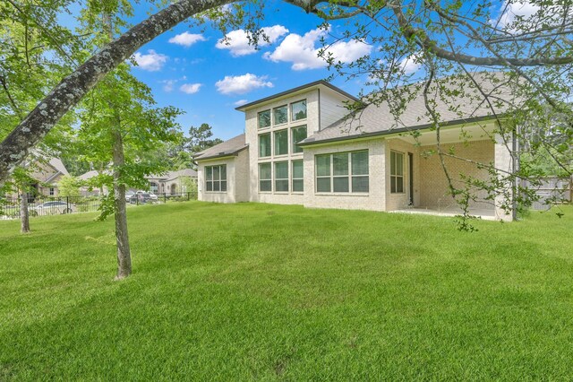 202 Twila Night Ct, Conroe, TX 77318 - back of house featuring a shingled roof and brick siding