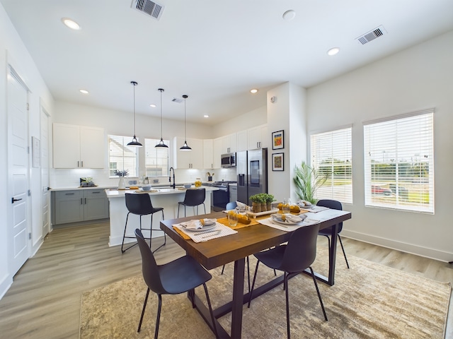 8315 Springwood Creek Ln, Houston, TX 77055 - dining area with light wood-style floors, recessed lighting, and baseboards