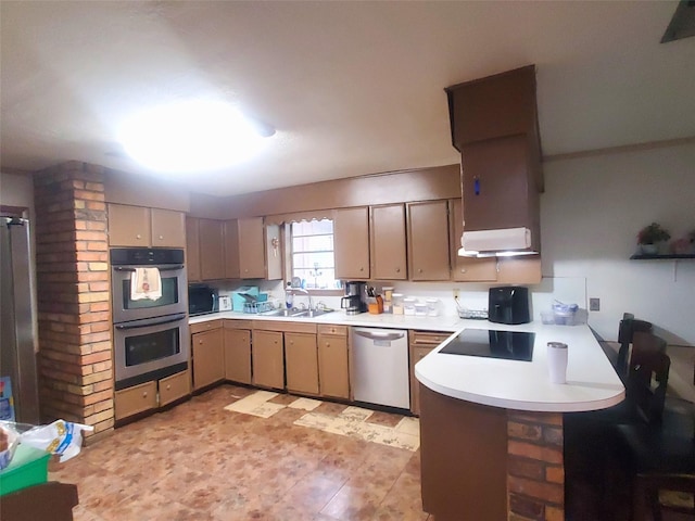 200 El Pinto Dr, Lumberton, TX 77657 - kitchen featuring appliances with stainless steel finishes, light countertops, a sink, and a peninsula