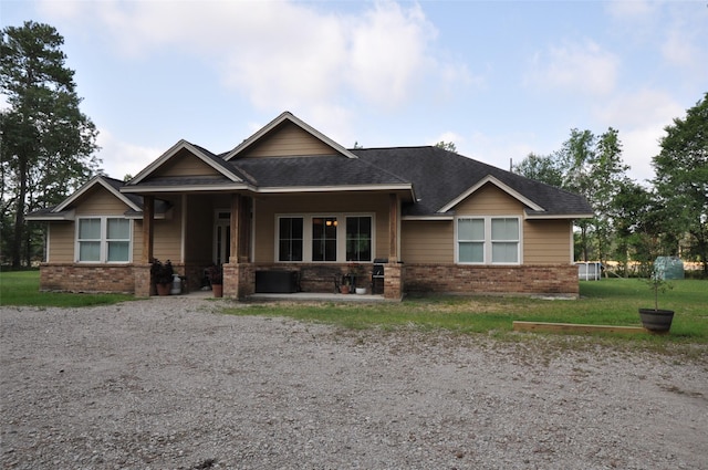 40029 Mill Creek Rd, Magnolia, TX 77354 - craftsman inspired home with brick siding, a shingled roof, and a front lawn