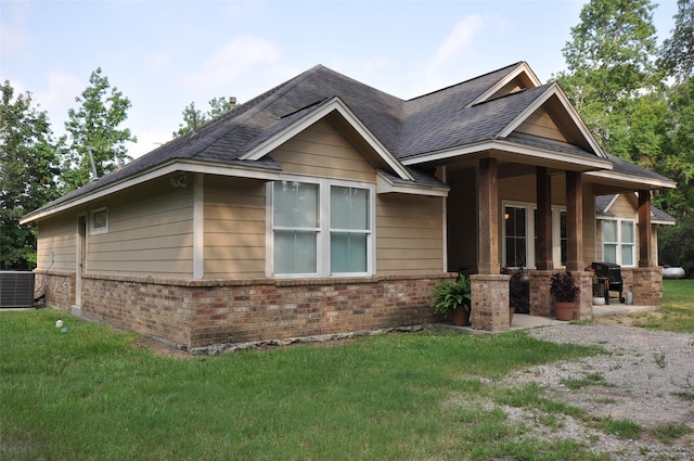 40029 Mill Creek Rd, Magnolia, TX 77354 - view of front of home featuring brick siding, central air condition unit, a front lawn, and a shingled roof