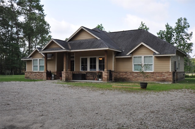 40029 Mill Creek Rd, Magnolia, TX 77354 - view of front of home with brick siding, covered porch, and roof with shingles