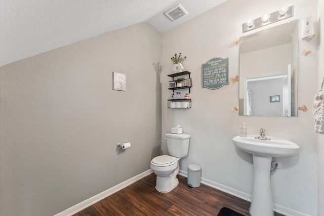 2415 Fallen Pine Ln, Houston, TX 77088 - bathroom featuring wood finished floors, lofted ceiling, toilet, and baseboards