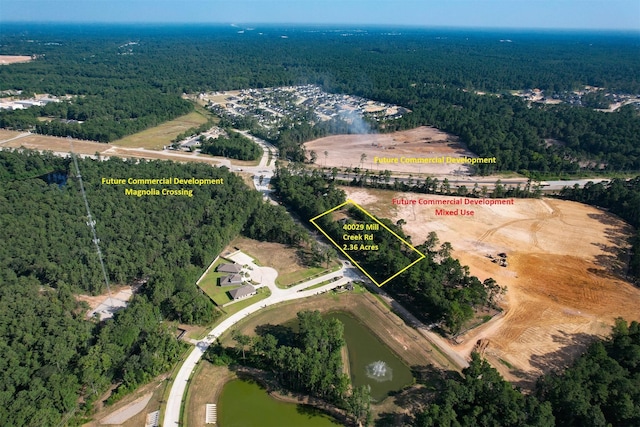 40103 Mill Creek Rd, Magnolia, TX 77354 - aerial view of property's location with a heavily wooded area, property parcel outlined, and a large body of water