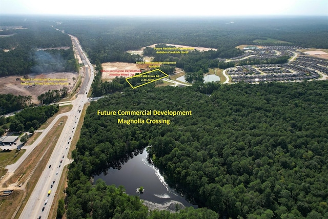 40103 Mill Creek Rd, Magnolia, TX 77354 - aerial view of property and surrounding area with a highway, a large body of water, and a forest