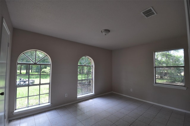 40103 Mill Creek Rd, Magnolia, TX 77354 - tiled spare room featuring baseboards and a textured ceiling