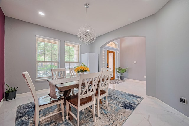 5615 Gemstone Park Rd, Richmond, TX 77407 - dining space featuring arched walkways, marble finish flooring, a chandelier, baseboards, and recessed lighting