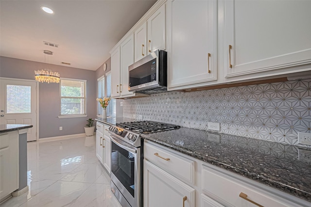 5615 Gemstone Park Rd, Richmond, TX 77407 - kitchen featuring appliances with stainless steel finishes, baseboards, backsplash, white cabinets, and light marble finish floors