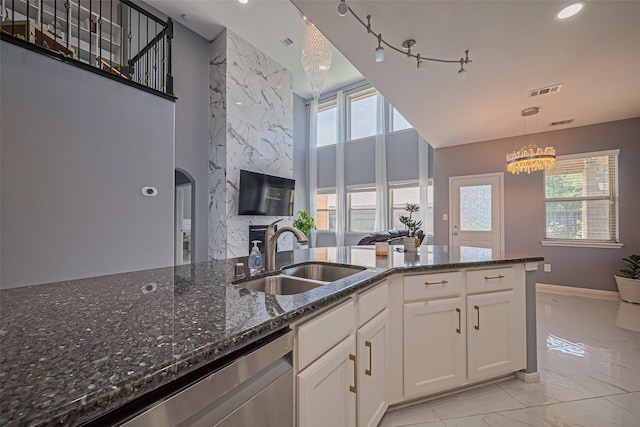 5615 Gemstone Park Rd, Richmond, TX 77407 - kitchen featuring a sink, light marble finish floors, a chandelier, dishwasher, and healthy amount of natural light