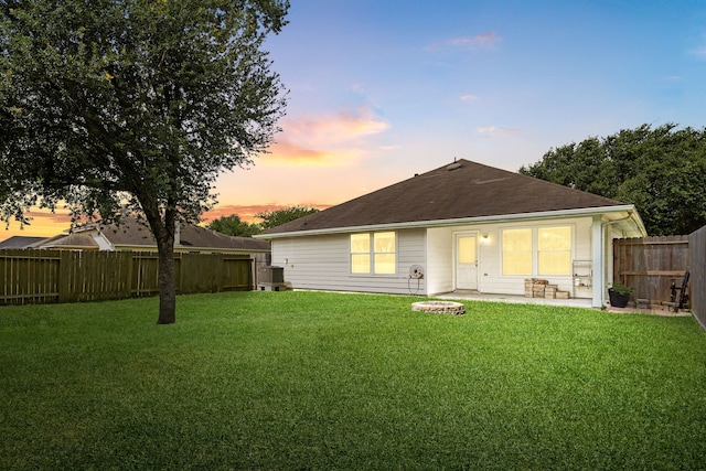 6733 Hidden Colony Ln, Dickinson, TX 77539 - back of property at dusk with a patio area, central air condition unit, and roof with shingles