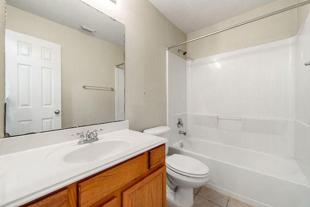 6733 Hidden Colony Ln, Dickinson, TX 77539 - bathroom featuring toilet, vanity, tile patterned floors, bathing tub / shower combination, and a textured ceiling