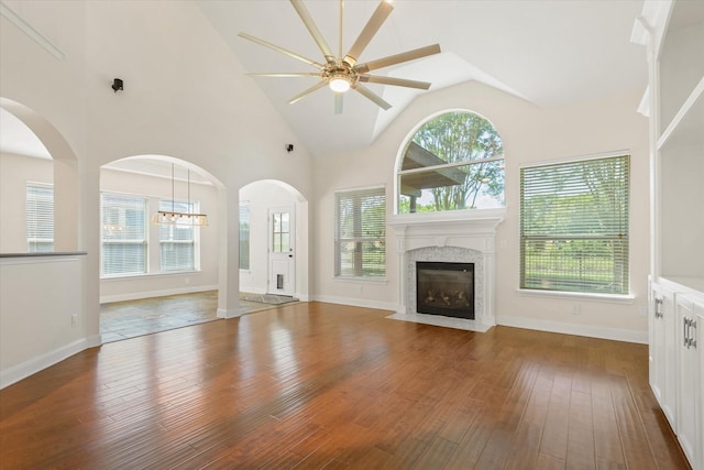 5122 Hidden Brook Ln, League City, TX 77573 - unfurnished living room with ceiling fan, wood-type flooring, a fireplace with flush hearth, healthy amount of natural light, and lofted ceiling