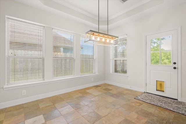 5122 Hidden Brook Ln, League City, TX 77573 - unfurnished dining area with stone tile flooring, baseboards, crown molding, a tray ceiling, and a chandelier