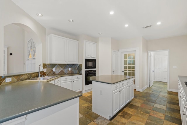 5122 Hidden Brook Ln, League City, TX 77573 - kitchen featuring black appliances, stone tile flooring, a sink, backsplash, and recessed lighting