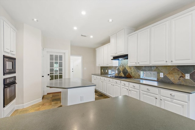 5122 Hidden Brook Ln, League City, TX 77573 - kitchen featuring black appliances, dark countertops, decorative backsplash, under cabinet range hood, and baseboards