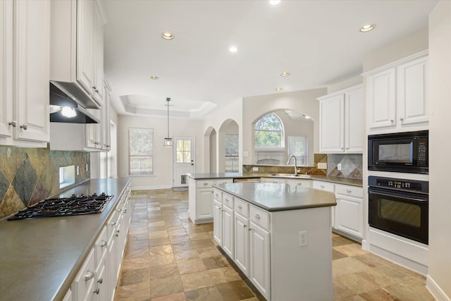 5122 Hidden Brook Ln, League City, TX 77573 - kitchen featuring black appliances, arched walkways, a sink, stone tile flooring, and recessed lighting