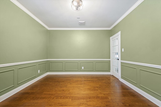 5122 Hidden Brook Ln, League City, TX 77573 - spare room with ornamental molding, a decorative wall, wood finished floors, and wainscoting