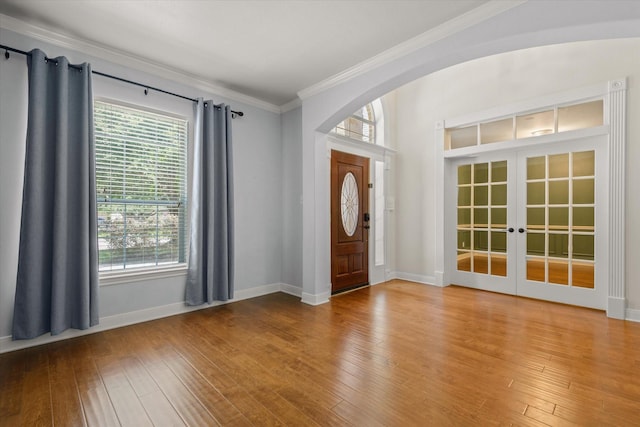 5122 Hidden Brook Ln, League City, TX 77573 - entryway featuring crown molding, hardwood / wood-style flooring, french doors, arched walkways, and baseboards
