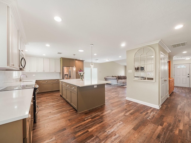 5402 Girnigoe Dr, Houston, TX 77084 - kitchen featuring stainless steel appliances, open floor plan, dark wood finished floors, a sink, and recessed lighting