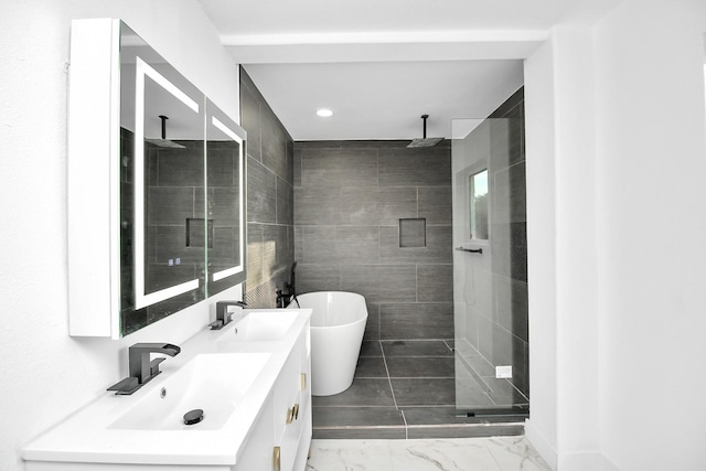 6035 Cartagena St, Houston, TX 77035 - bathroom with a stall shower, double vanity, a freestanding tub, marble look tile flooring, and recessed lighting