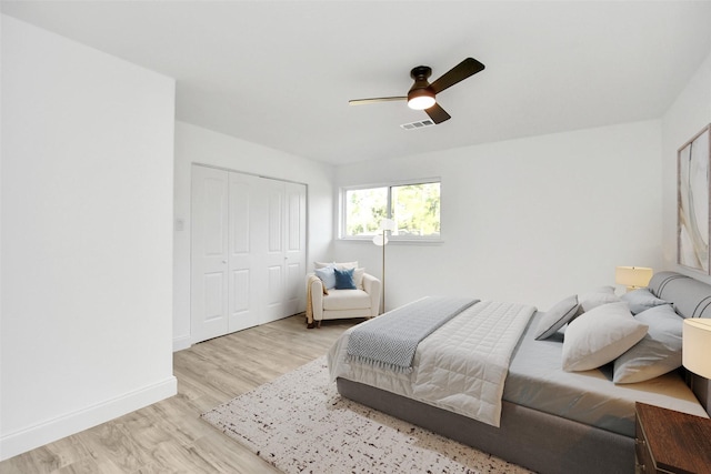 6035 Cartagena St, Houston, TX 77035 - bedroom featuring light wood-style floors, a closet, baseboards, and ceiling fan