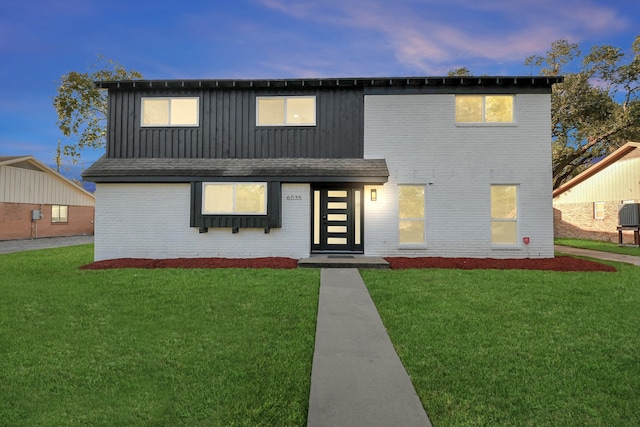 6035 Cartagena St, Houston, TX 77035 - view of front of house featuring brick siding, a yard, board and batten siding, and cooling unit