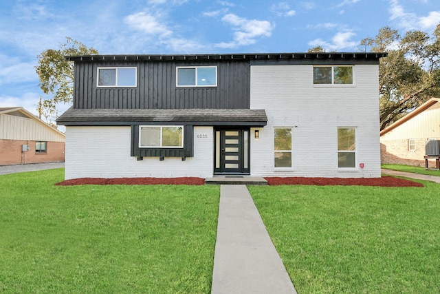 6035 Cartagena St, Houston, TX 77035 - view of front facade with a front yard, brick siding, board and batten siding, and central AC