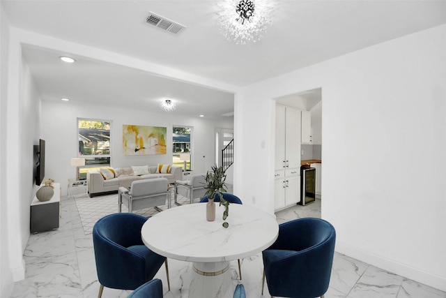 6035 Cartagena St, Houston, TX 77035 - dining space with light marble finish floors, beverage cooler, stairs, recessed lighting, and baseboards