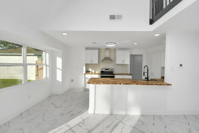 6035 Cartagena St, Houston, TX 77035 - kitchen featuring wooden counters, stainless steel electric stove, wall chimney range hood, a sink, and light marble finish flooring