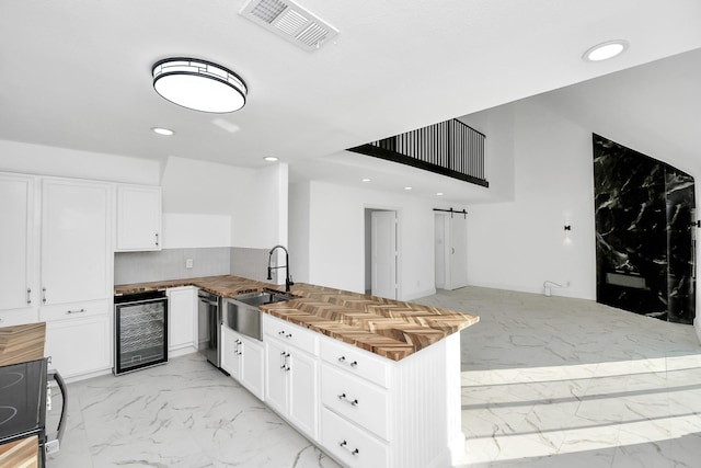 6035 Cartagena St, Houston, TX 77035 - kitchen with wine cooler, a sink, light marble finish floors, dishwasher, and a peninsula