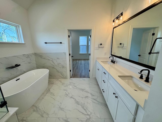 1631 Beall St, Houston, TX 77008 - bathroom with marble finish flooring, plenty of natural light, a freestanding tub, double vanity, and wainscoting