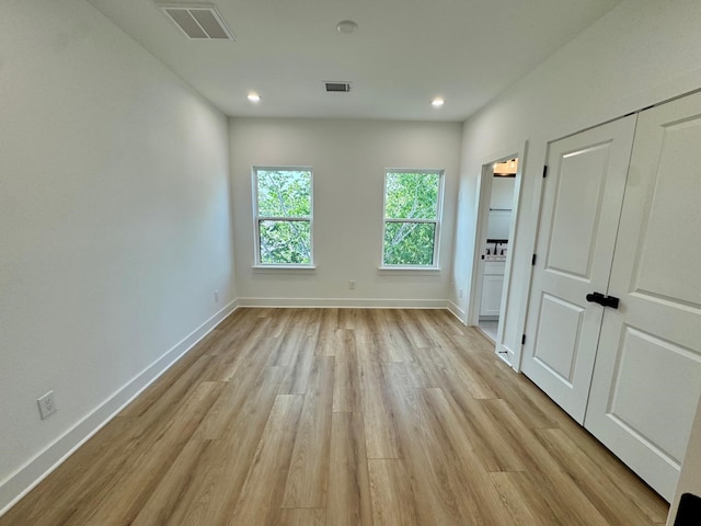 1631 Beall St, Houston, TX 77008 - unfurnished bedroom with light wood-type flooring, baseboards, recessed lighting, and ensuite bath
