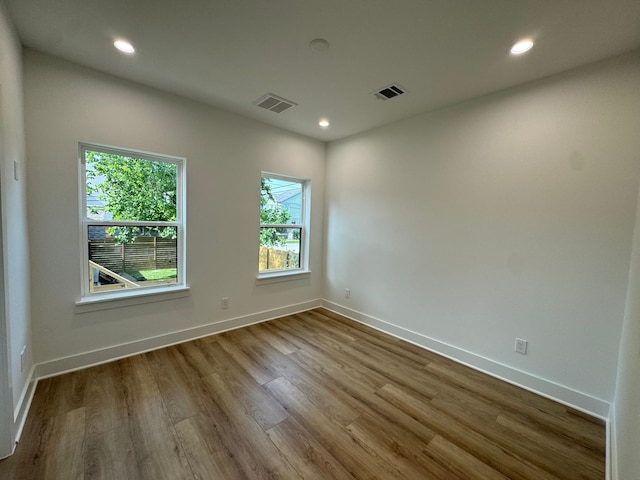 1631 Beall St, Houston, TX 77008 - empty room featuring wood finished floors, baseboards, and recessed lighting