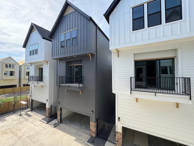 1631 Beall St, Houston, TX 77008 - view of property exterior featuring board and batten siding, fence, and a balcony