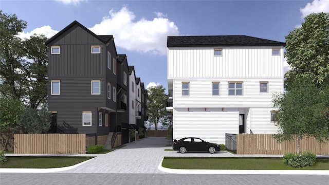 1631 Beall St, Houston, TX 77008 - view of front of home featuring board and batten siding, fence, and driveway