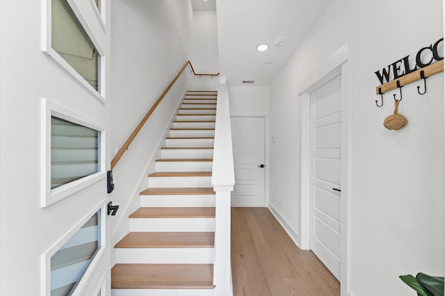 8303 Springwood Creek Ln, Houston, TX 77055 - staircase with wood finished floors and recessed lighting