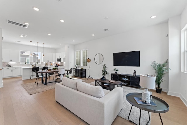 8303 Springwood Creek Ln, Houston, TX 77055 - living room featuring light wood finished floors and recessed lighting