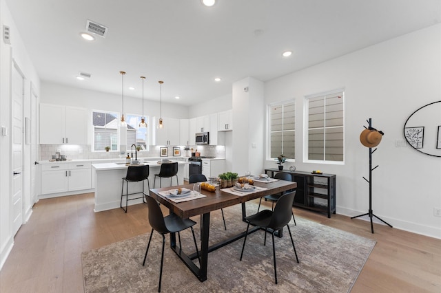 8303 Springwood Creek Ln, Houston, TX 77055 - dining space with light wood-style flooring and recessed lighting