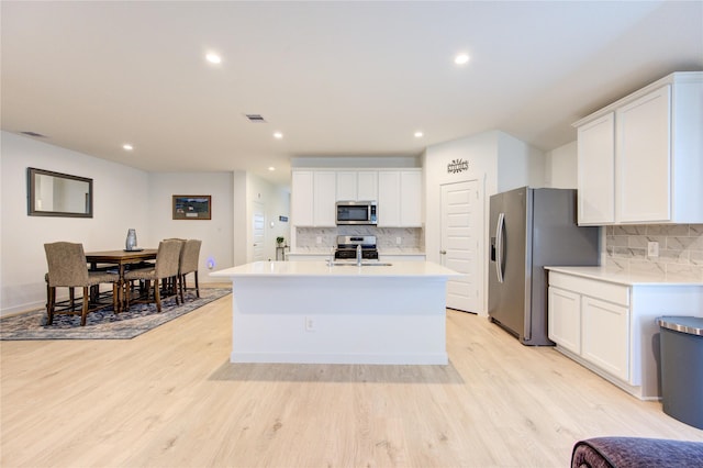 31814 Hallington Hill Ln, Fulshear, TX 77441 - kitchen featuring stainless steel appliances, backsplash, light countertops, light wood-style floors, and recessed lighting