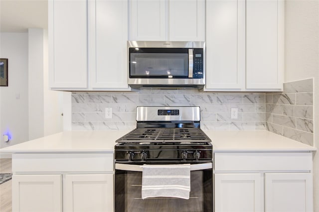 31814 Hallington Hill Ln, Fulshear, TX 77441 - kitchen with appliances with stainless steel finishes, light countertops, backsplash, and white cabinets
