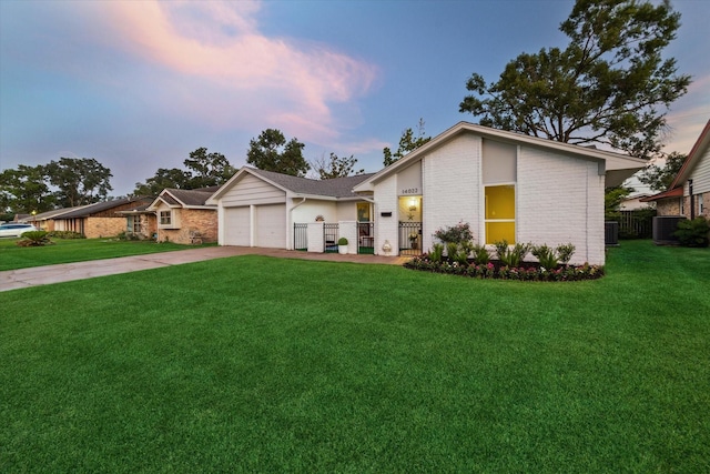 14022 Roundstone Ln, Houston, TX 77015 - mid-century inspired home with brick siding, a garage, concrete driveway, and central AC unit