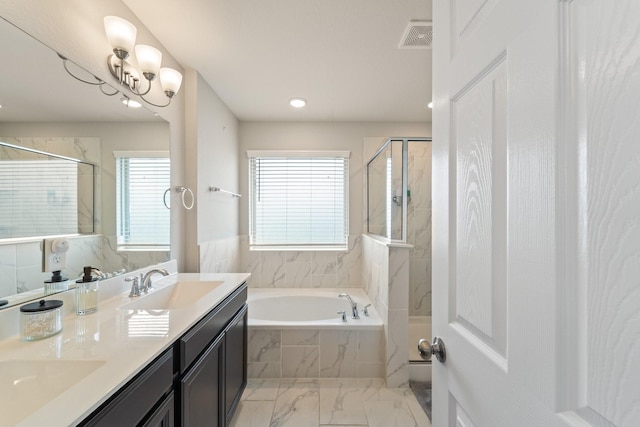 8957 Monterey View Dr, Houston, TX 77080 - bathroom featuring marble finish flooring, a garden tub, a stall shower, double vanity, and recessed lighting