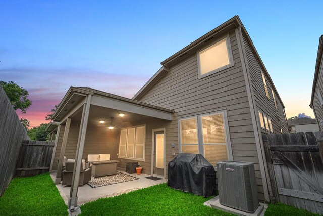 8957 Monterey View Dr, Houston, TX 77080 - back of property at dusk featuring central air condition unit and a patio area